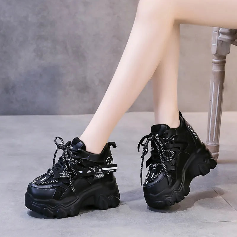 White women's low-top platform trainers with breathable mesh and a black cross-strap.