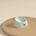 Green tilted pet bowl with 15-degree angle for cervical spine support on white background