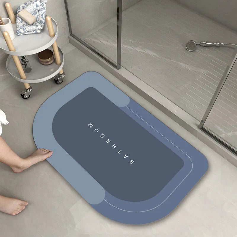 Blue oval blended bathroom floor mat on tiled floor next to a bath.