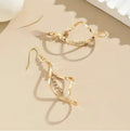 Gold geometric spiral drop earrings with oval detailing for women