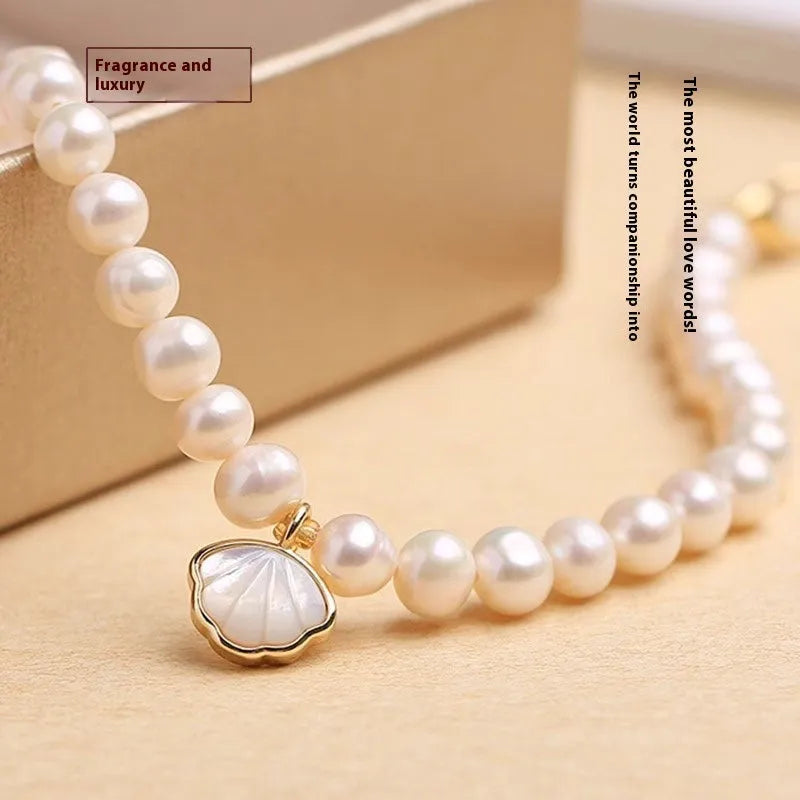Women's freshwater pearl bracelet with fan-shaped design showing elastic and chain fastening options
