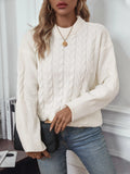Women's loose beige round neck pullover sweater on a hanger.