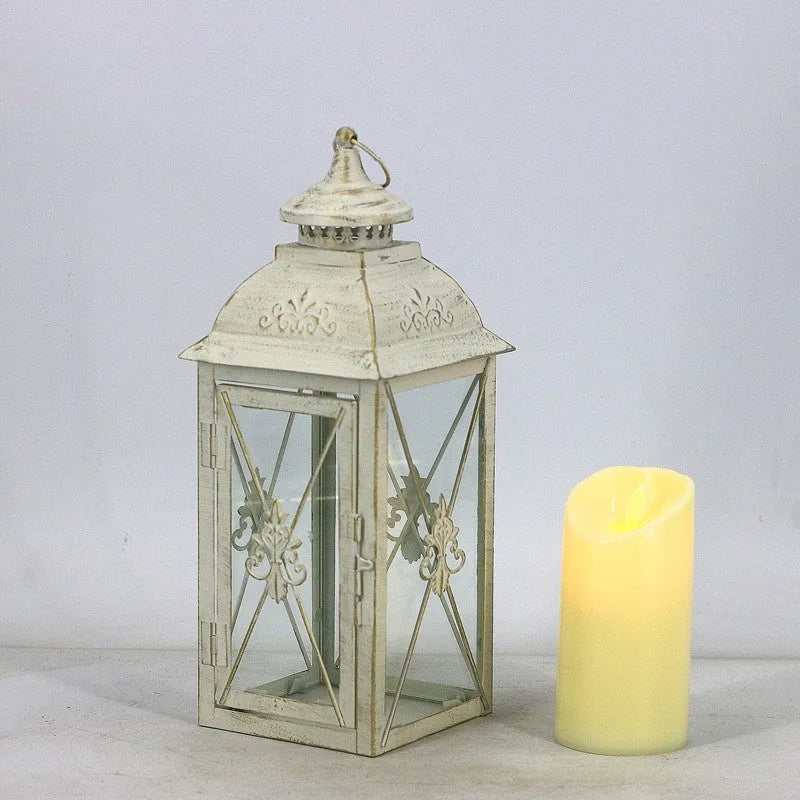 Black and white wrought iron floor-standing storm lantern with tempered glass panels in three sizes for courtyards.