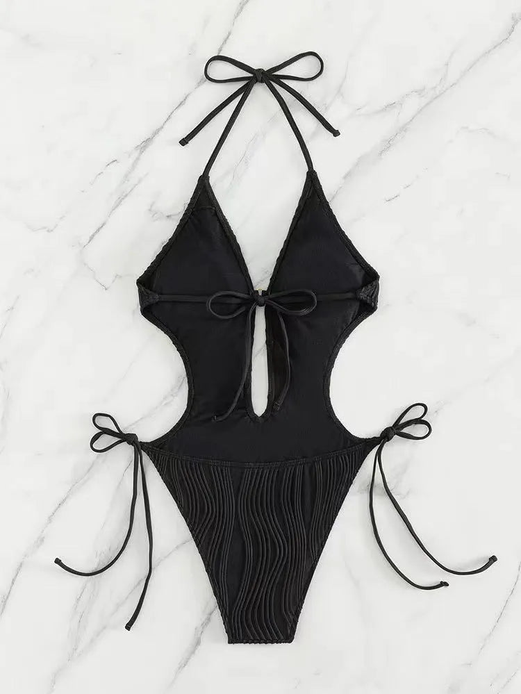 Women's black lace-up triangle bikini swimsuit on mannequin showing adjustable top details