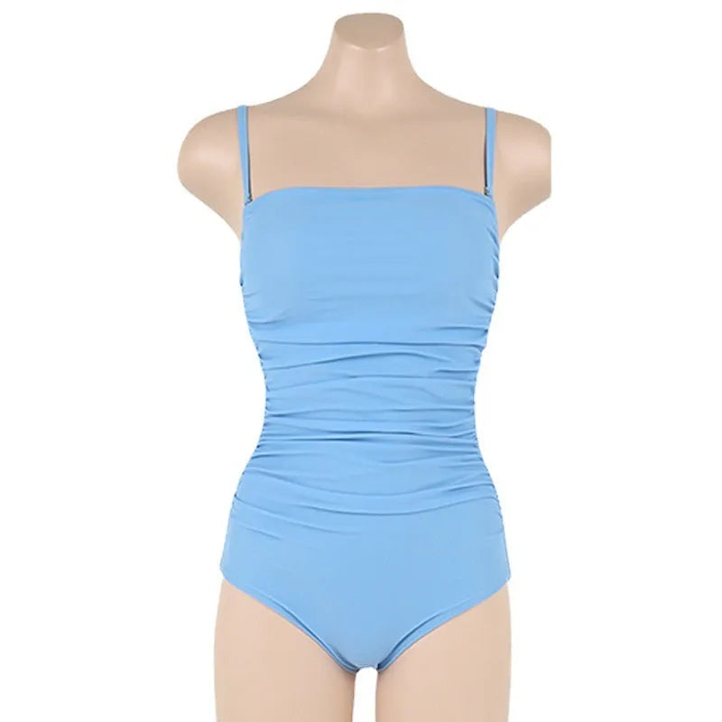 Sling top one-piece swimsuit with belly pleats in blue, shown on a model.
