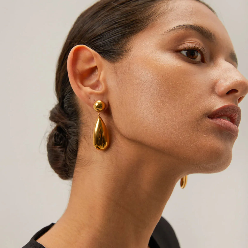 Gold electroplated stainless steel earrings with geometric hemisphere water drop pendant design