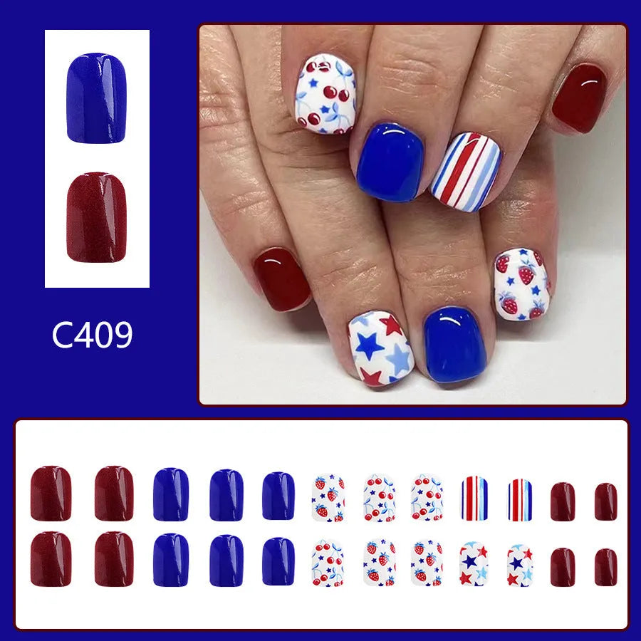 Short glossy false nails with strawberry and cherry patterns in red and blue colour combinations