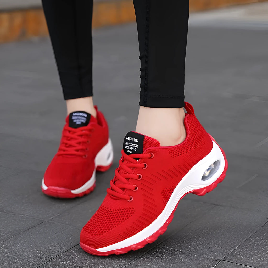 Red women's mesh lace-up low-top sneakers with a round toe and flat PU sole on a white background.