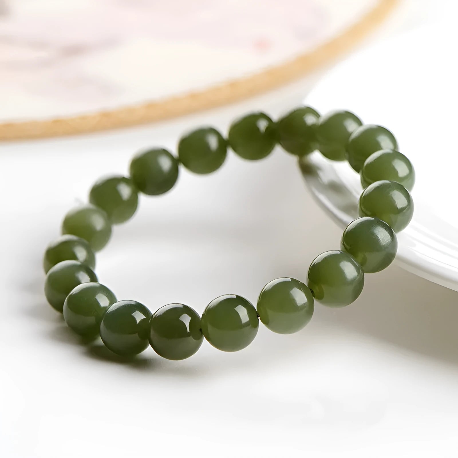 Polished Hetian jade ball bracelet in ice-like clear water colours on a wrist.