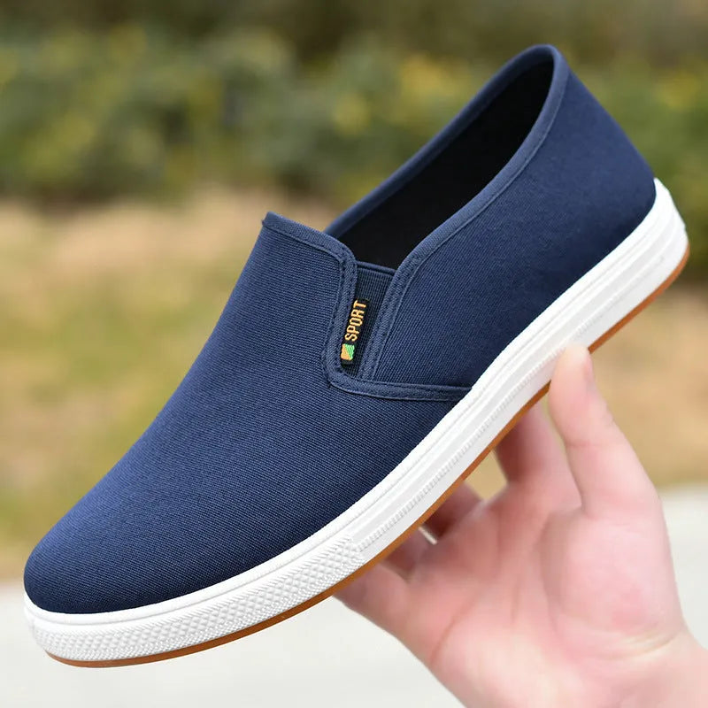 Men's black and blue slip-on canvas trainers with round toe and shallow mouth design