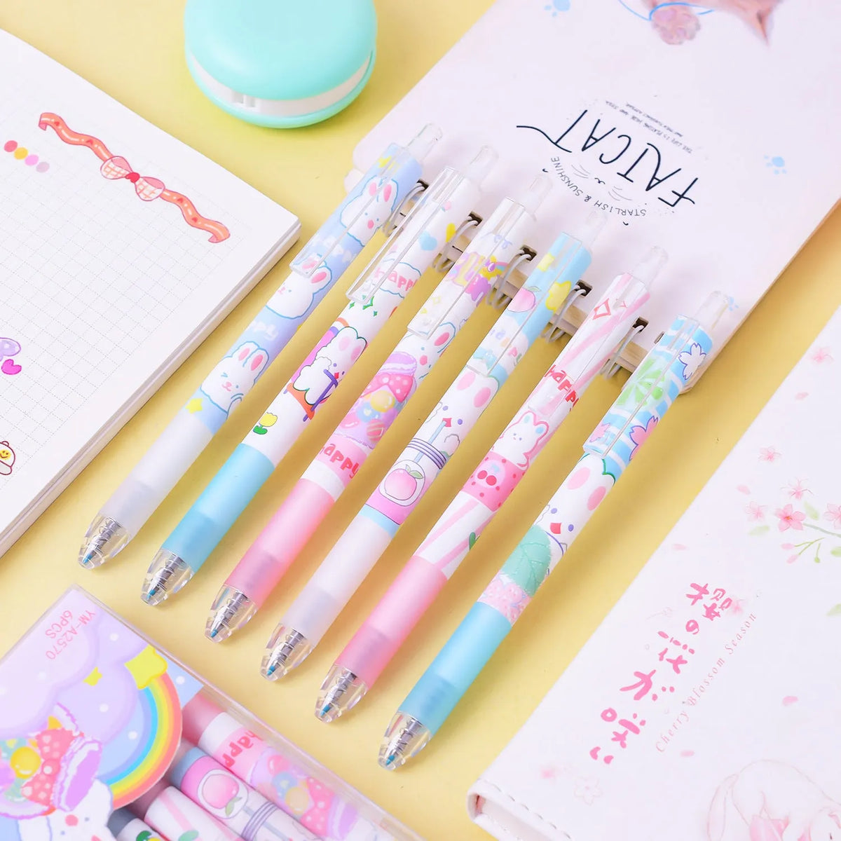 Six cartoon bunny design black ballpoint pens with 0.5mm tips laid out on a surface.