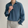 Men's loose lapel casual long sleeve shirt in a solid colour on a hanger