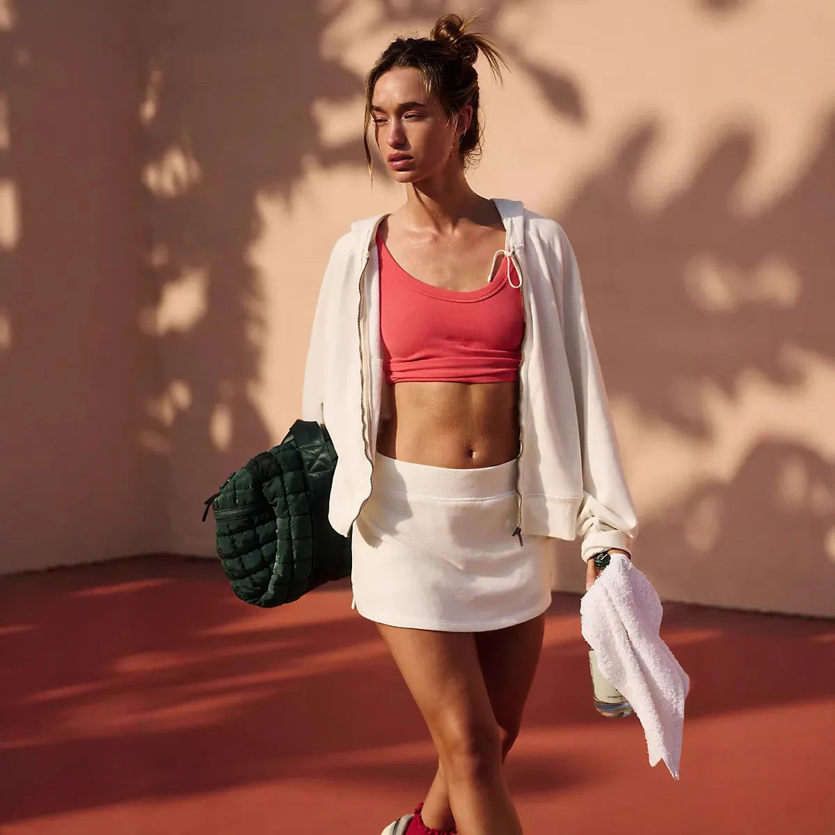 Women's casual hooded jacket and skirt outfit set in streetwear style with zipper details