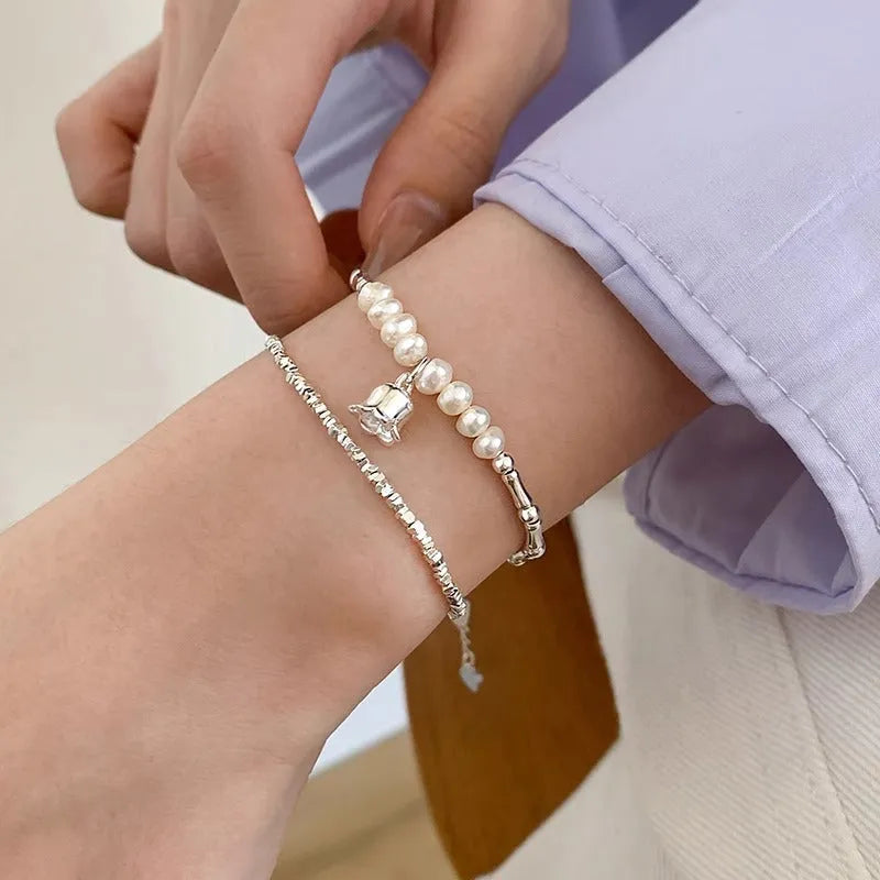 Silver pearl Lily of the Valley pendant bracelet on display