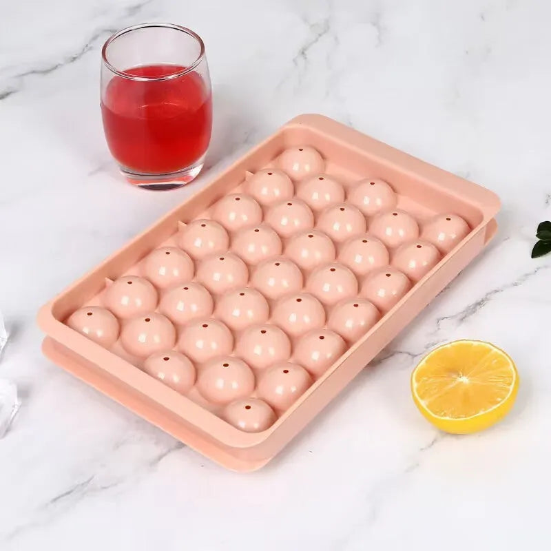 Blue silicone ice cube tray with lid showing 33 round compartments