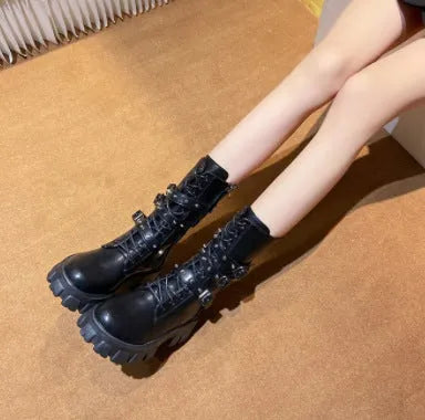 Women's black mid-calf buckle boots with side zipper and round toe, showing metal buckle detail