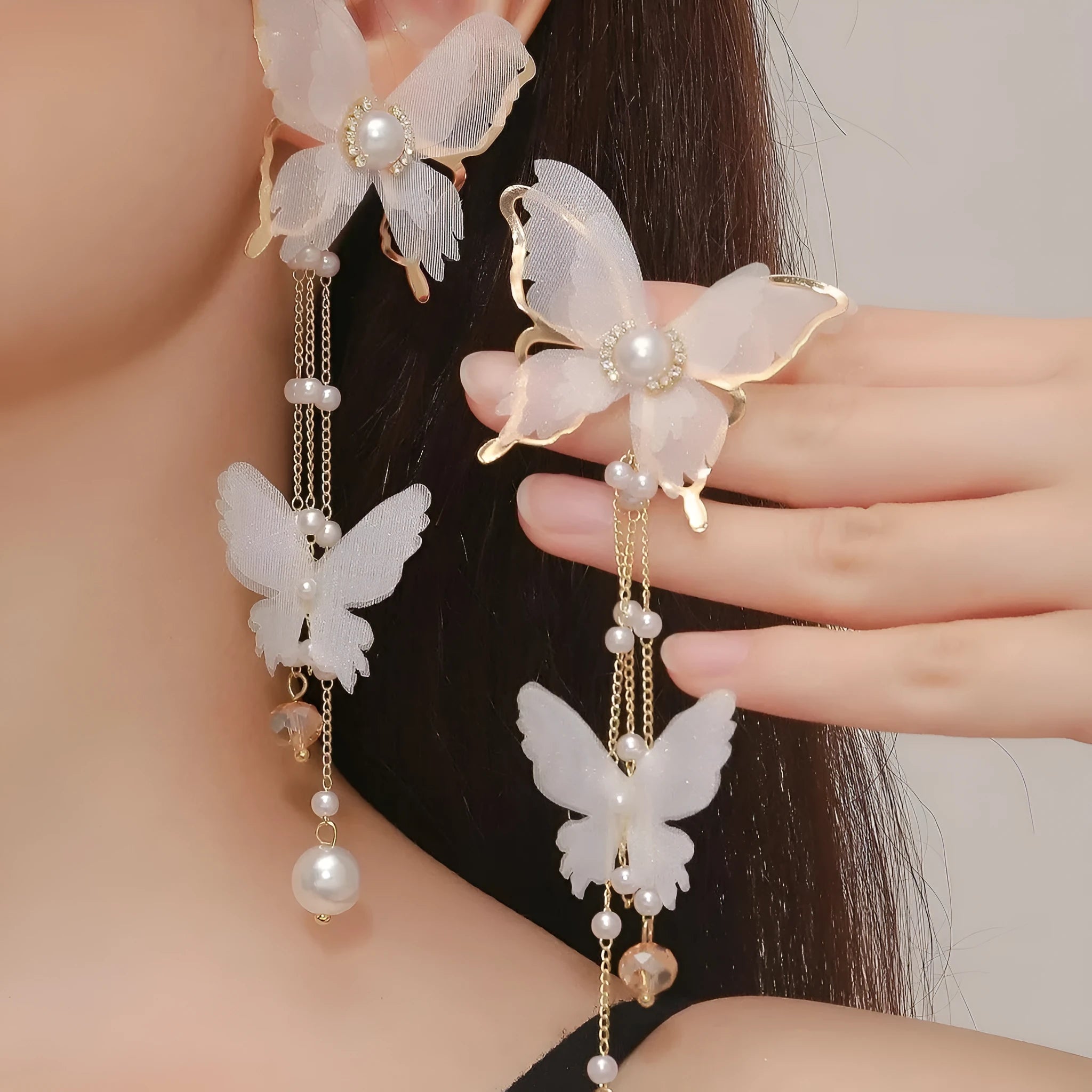 Butterfly-shaped earrings with rhinestones, pearls, and tassel lace on copper alloy with white electroplated finish
