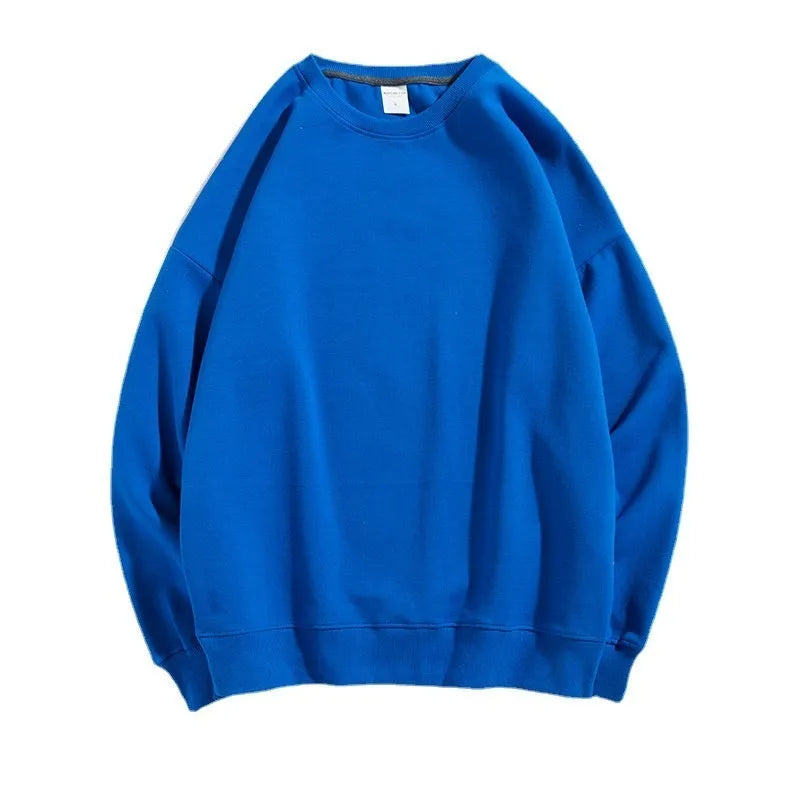 A woman wearing a loose-fit, off shoulder, long sleeve cotton pullover sweater in a solid colour.
