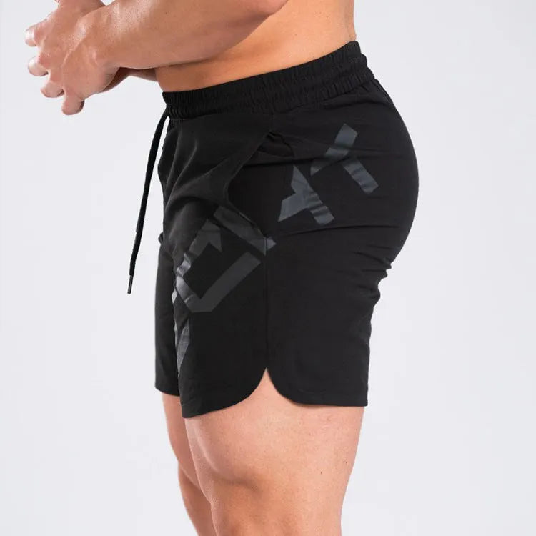 Men's black knee-length training shorts with an elastic waistband, made from quick-dry nylon blend fabric.