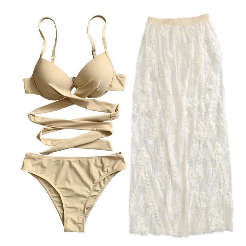 Women's creamy white backless push-up bikini three-piece set with a skirt on a neutral background.