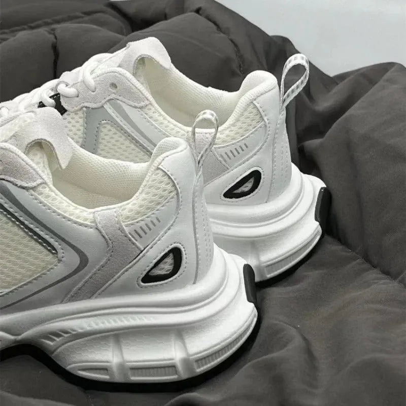 Beige mesh platform sports shoe with a wedge heel and front lace-up design on a white background.