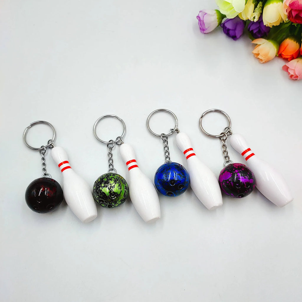 Mini bowling ball keychain pendant in PVC metal available in four colours: dark red, blue, purple, green