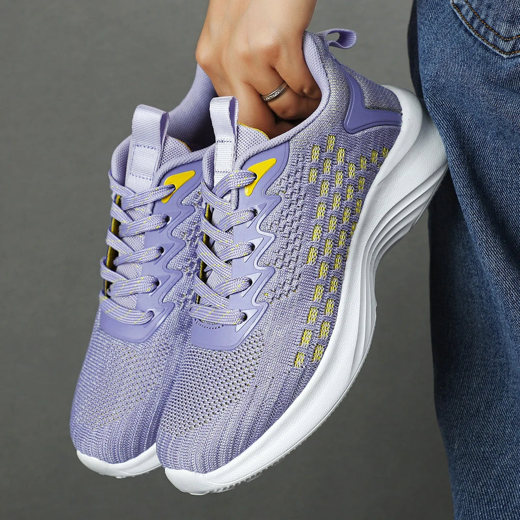 Women's lavender purple Flyknit running shoes with mesh lining and striped pattern on a white background.