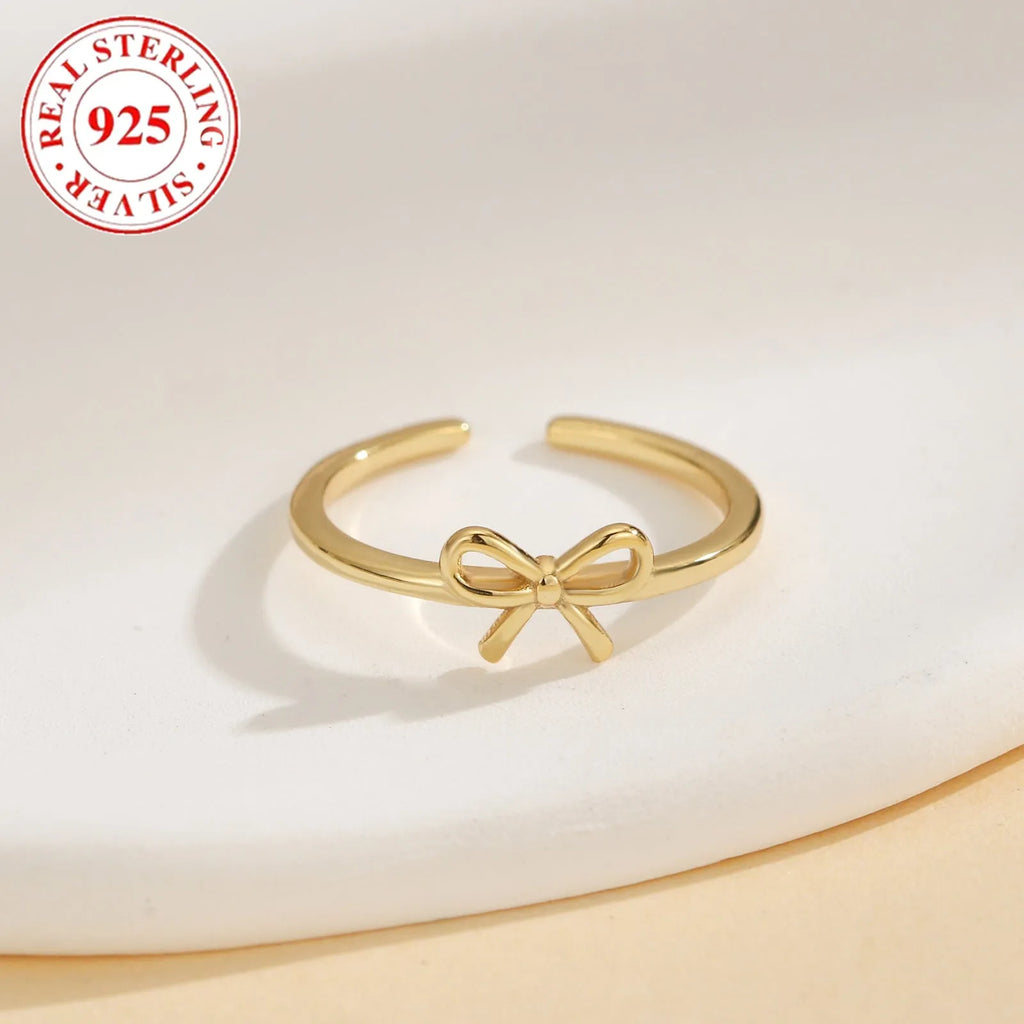S925 sterling silver bow opening toe ring in gold F026 on a woman's toe