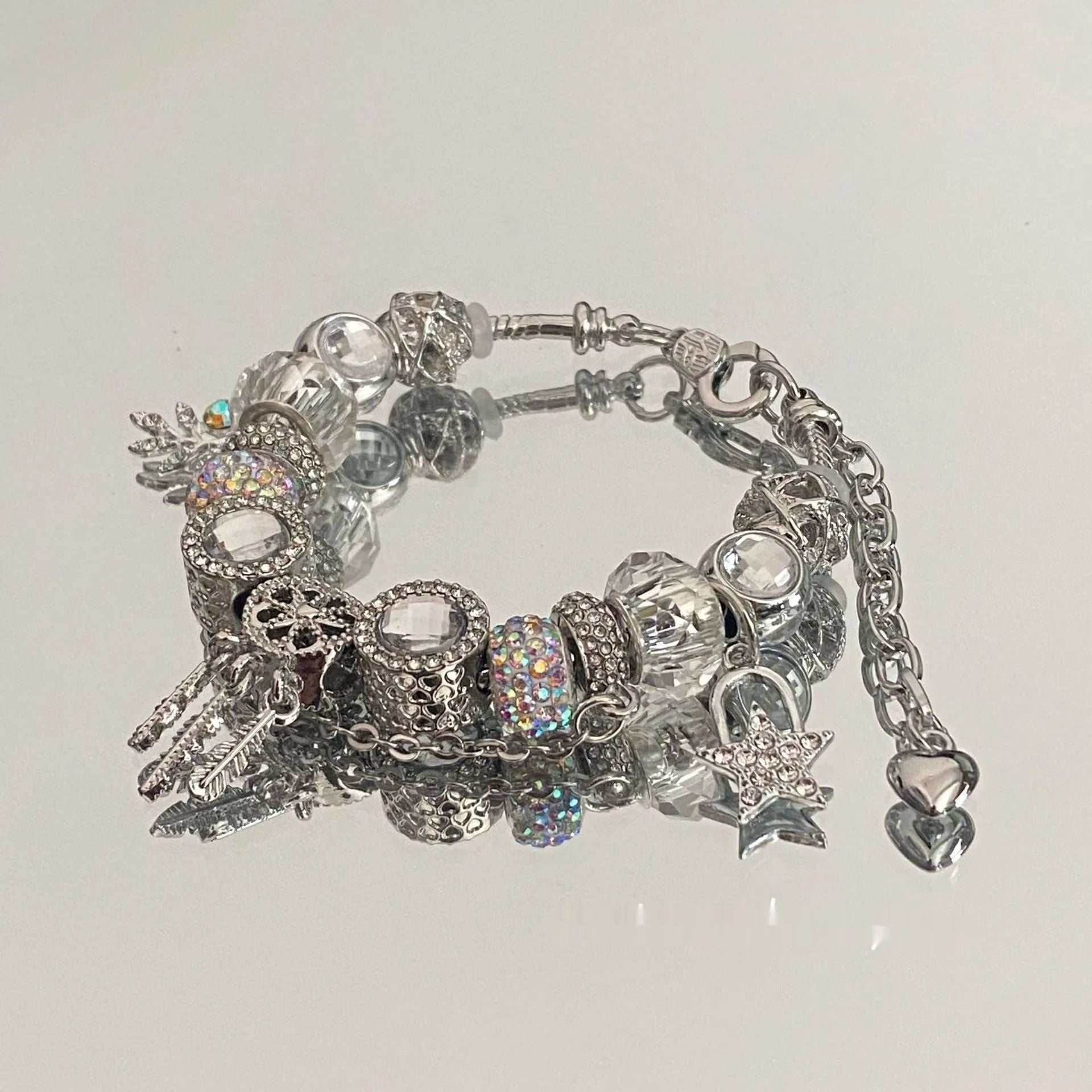 Women's dream catcher star bracelet with colourful crystals and electroplated finish on a white background
