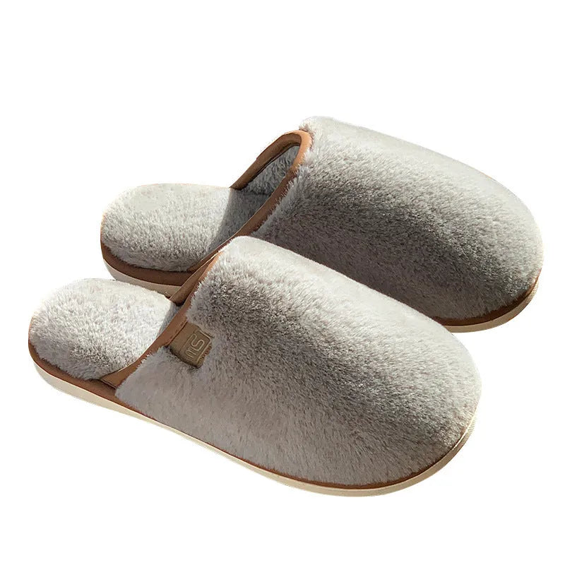 A pair of solid colour plush winter slippers with a non-slip PVC sole, shown in available colours.