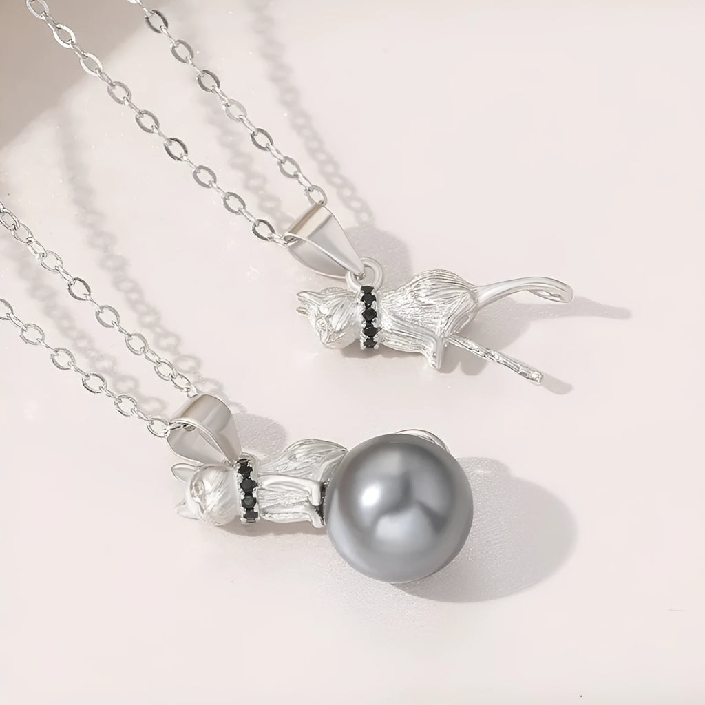 Close-up of a sterling silver cat pendant necklace on a chain with an electroplated finish.