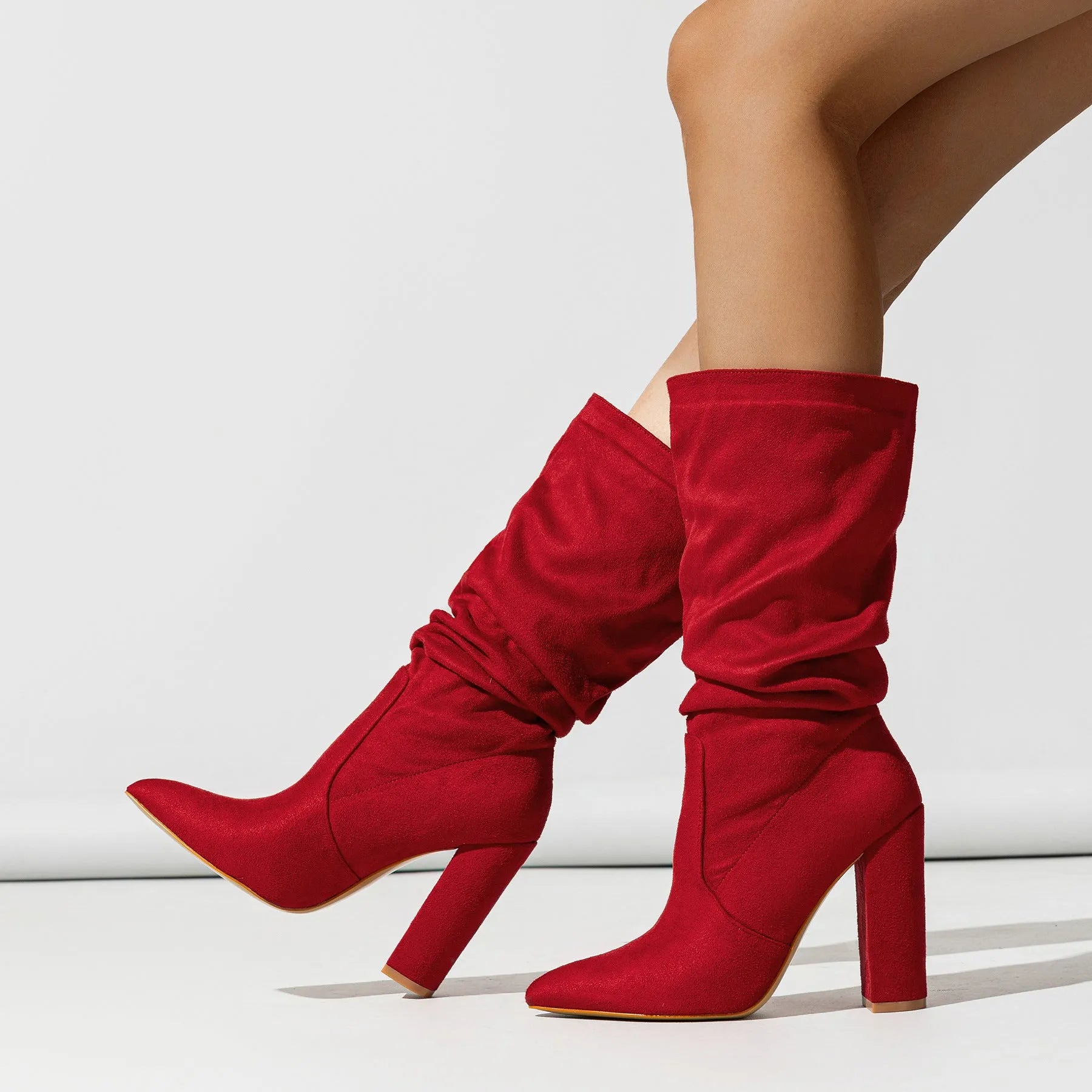 Women's black suede boots with chunky high heel and pointed toe design
