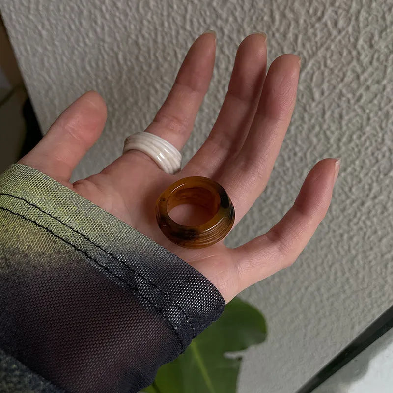 Chinese style irregular geometric resin ring in wide band design showing brown and white colour options