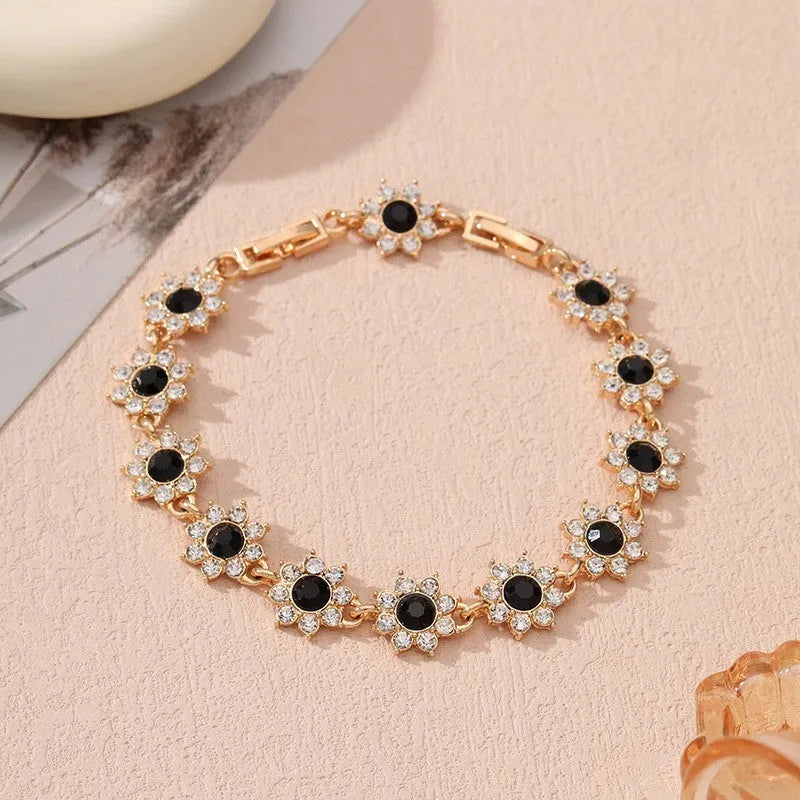 Electroplated zinc alloy flower bracelet with coloured gems in gold and silver colour options