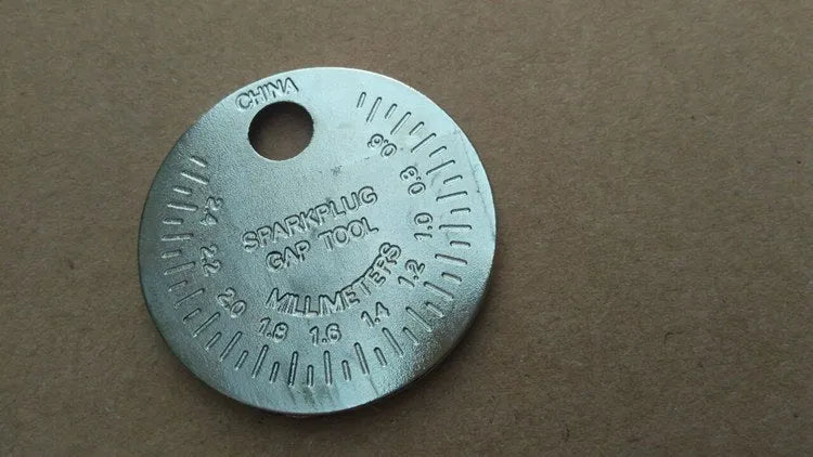 Round zinc alloy spark plug gauge with dual metric and inch scales