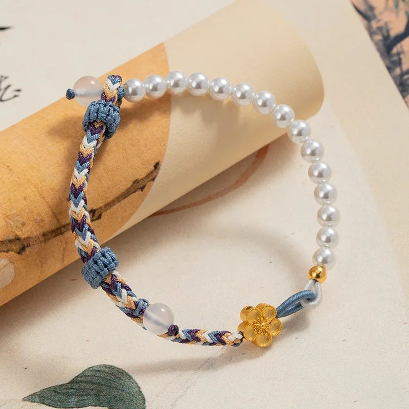 Peach-coloured Chinese flower weaving carrying strap bracelet with pearl accents on cord material