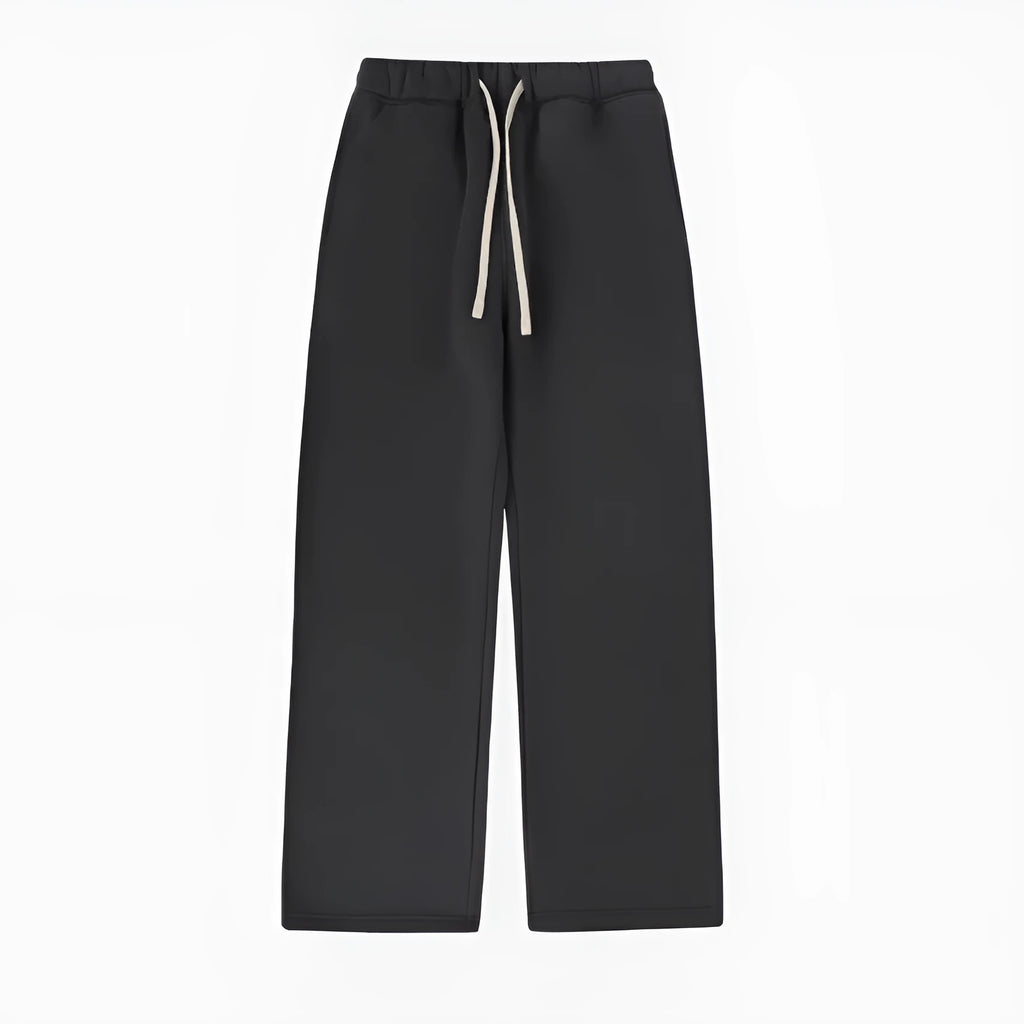 Man wearing black fleece-lined loose-fit sweatpants with a drawstring waist.