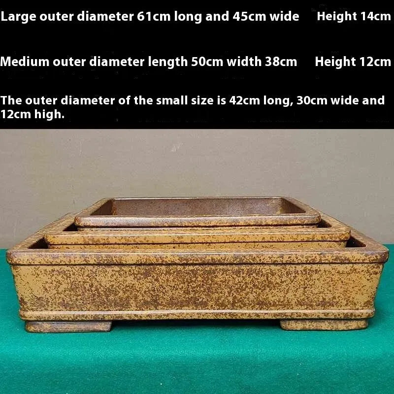 Straight shallow rectangular Yixing zisha purple sand flowerpot on a solid surface.