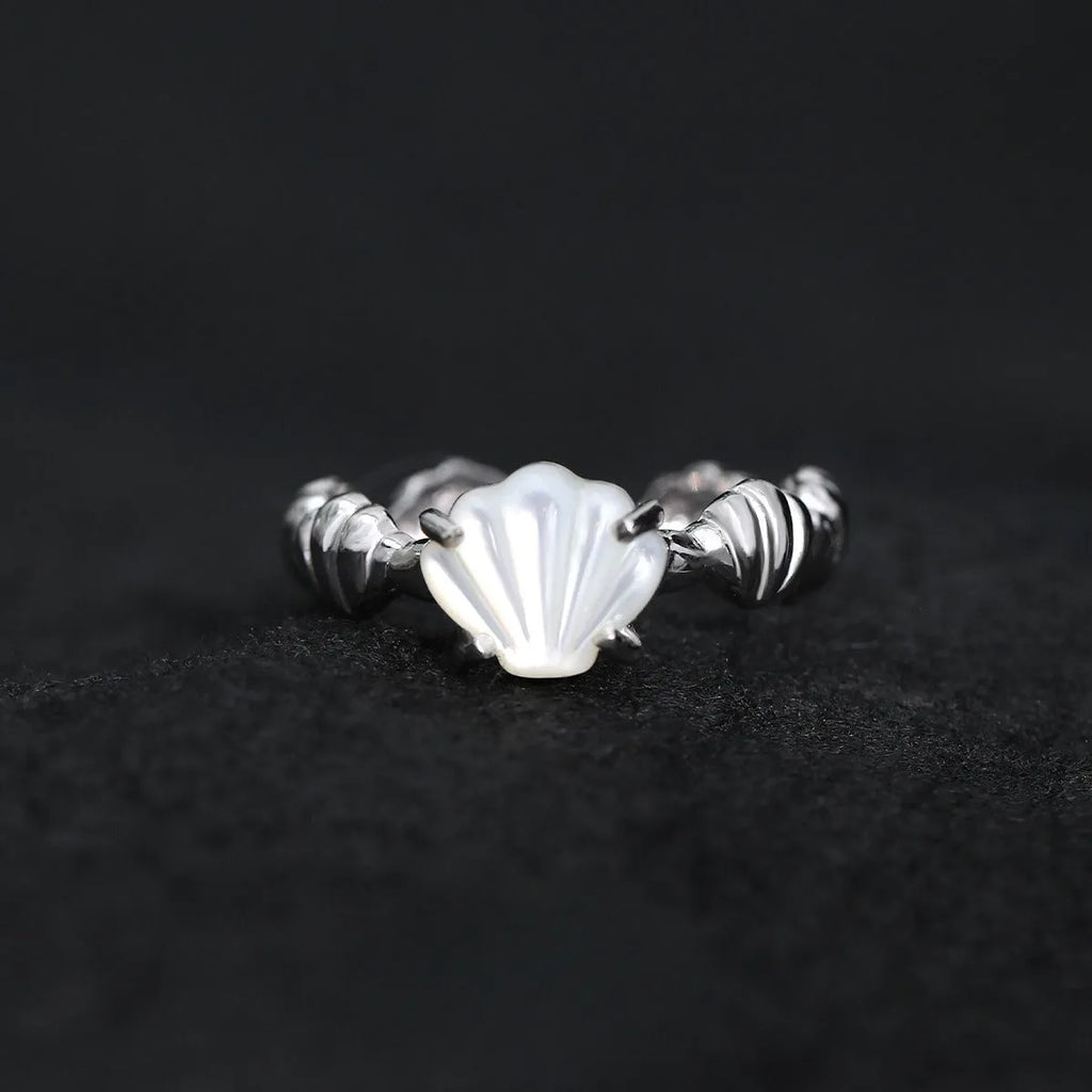 Women's adjustable silver ring with shell design and tiger eye accents in gold electroplated finish.