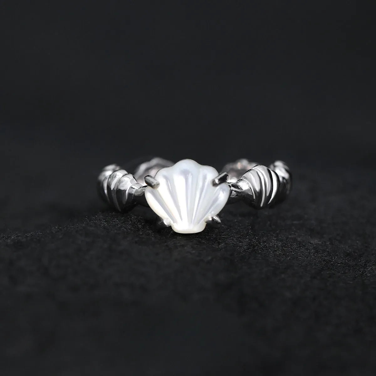 Women's adjustable silver ring with shell design and tiger eye accents in gold electroplated finish.