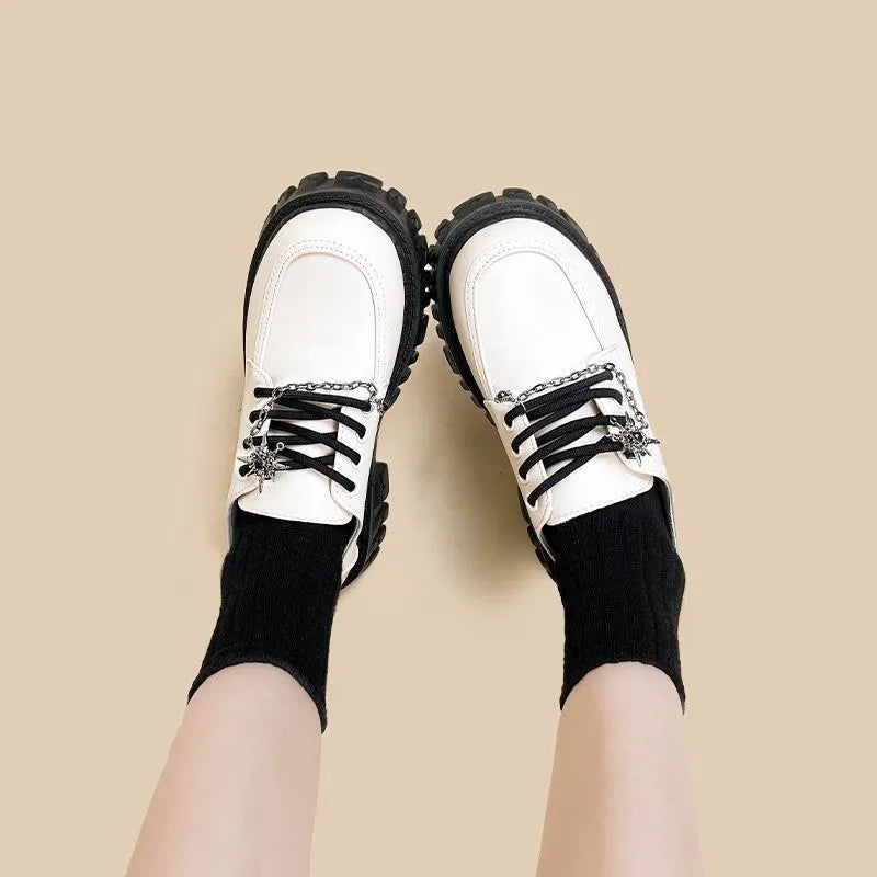 Women's Duke Asterism coloured loafers with a metal cross strap and round toe.