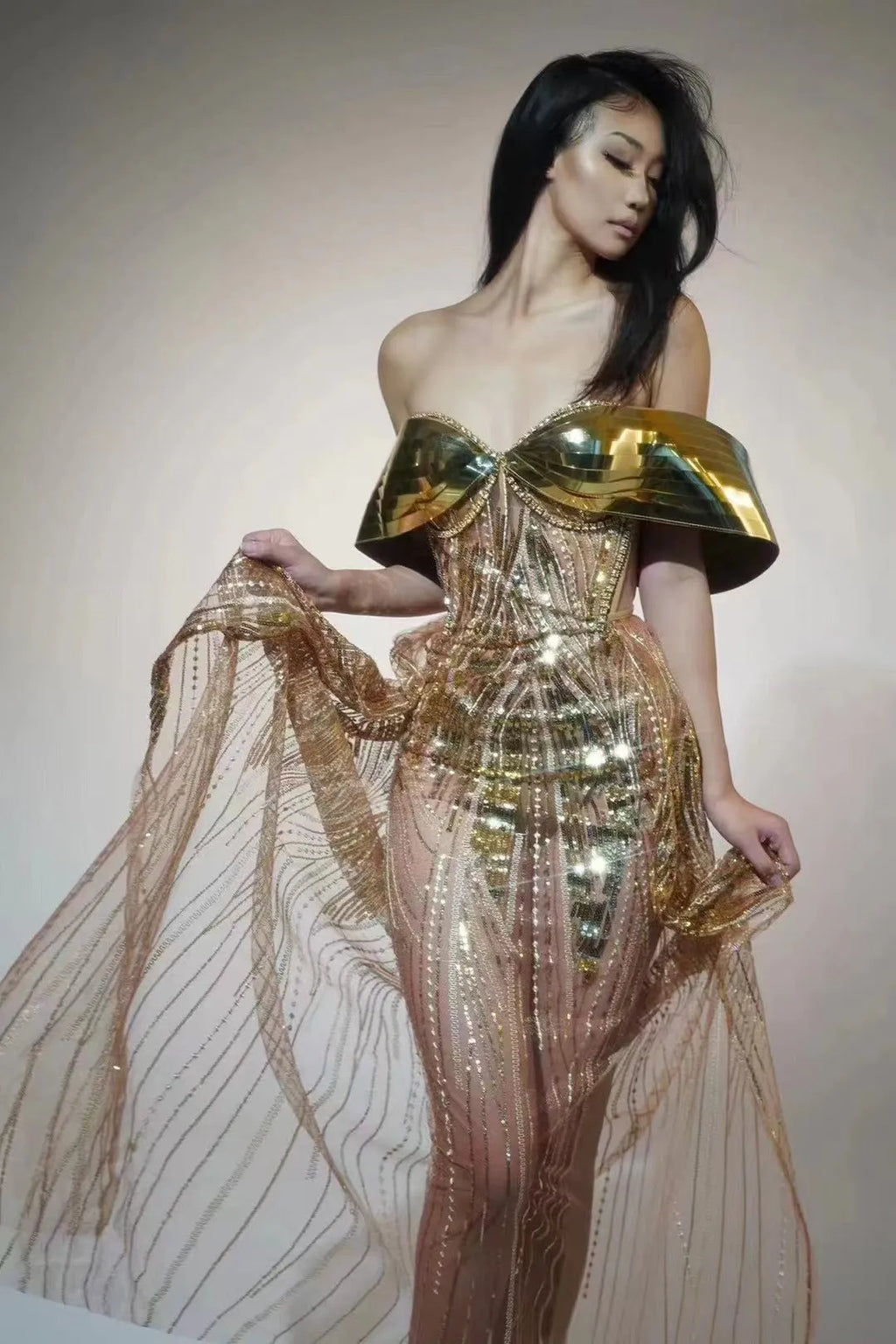 Gold strapless sequined evening dress with a long tulle skirt and a high side split.