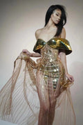 Gold strapless sequined evening dress with a long tulle skirt and a high side split.