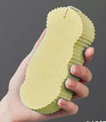 White 3D fish scale pattern bath sponge ball with hanging loop on a bathroom background.