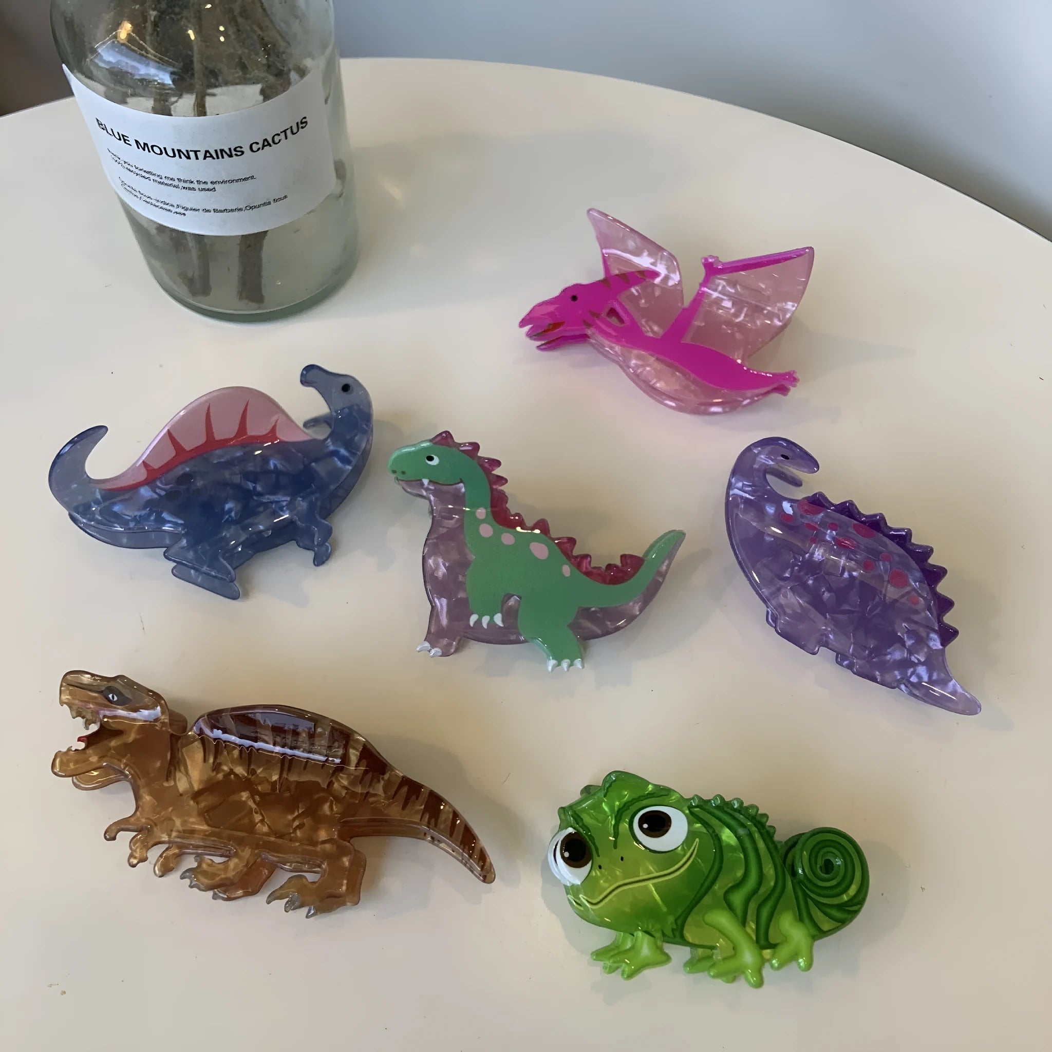 Colourful dinosaur acrylic jaw clip hairpin showing grip design with dinosaur motif