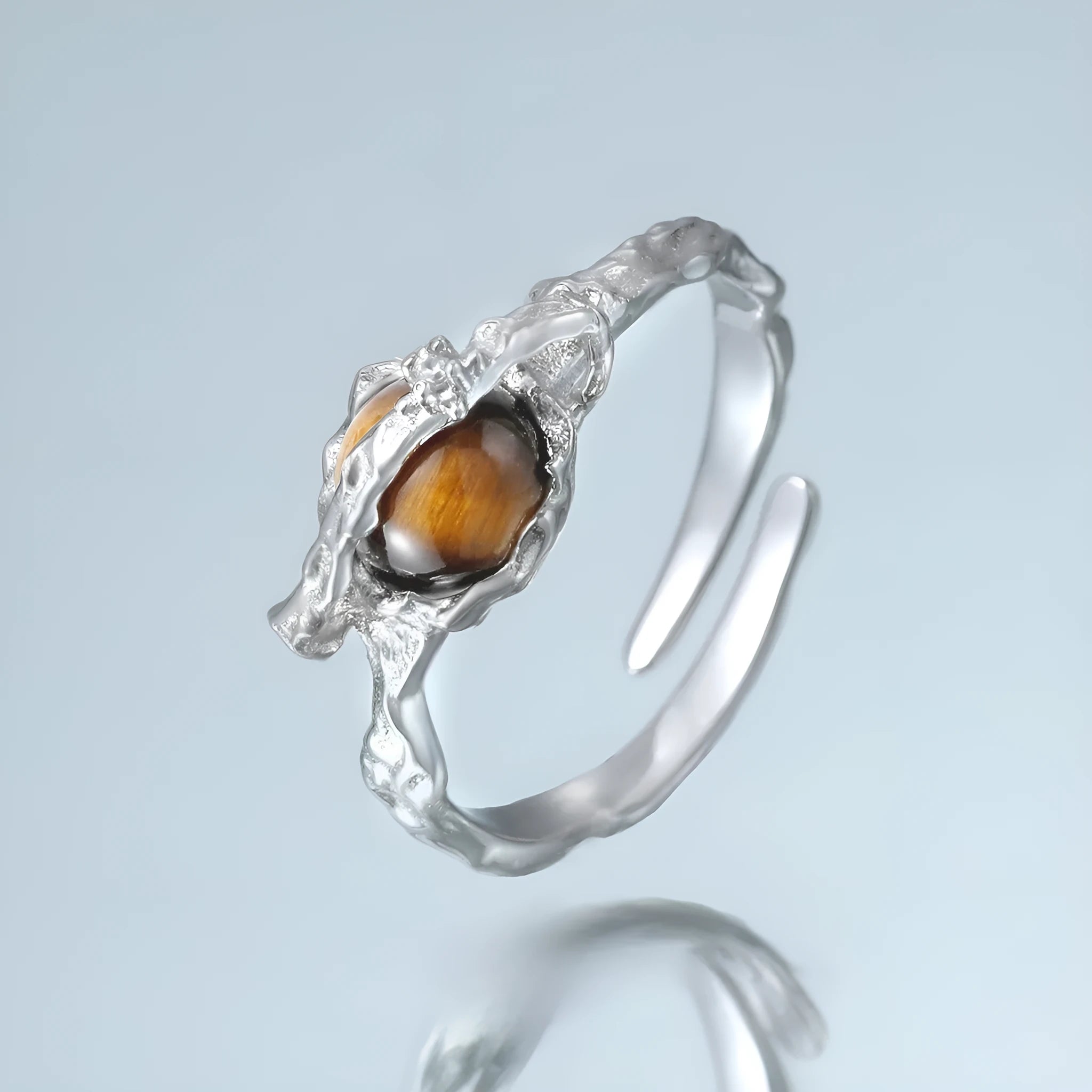 Women's adjustable Saturn design ring in silver with white gold electroplating.