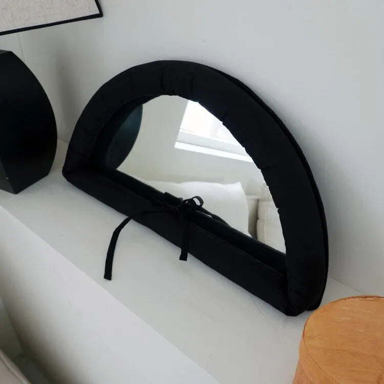 Hanging soft cotton-filled fabric mirror in solid colour on wall