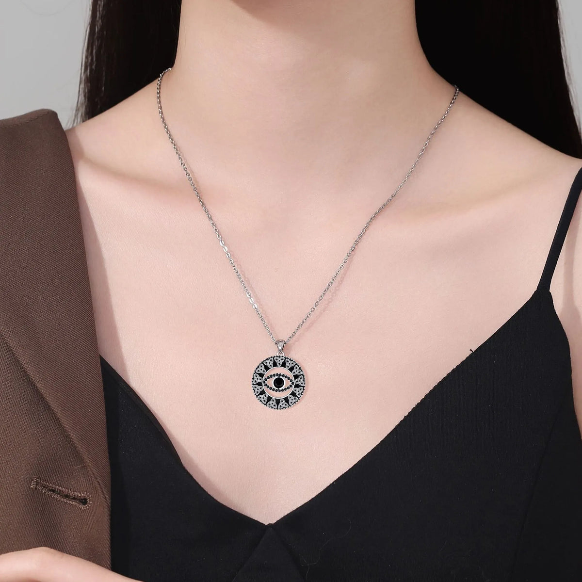 Copper Devil's Eye necklace with cross chain style pendant and electroplated finish.