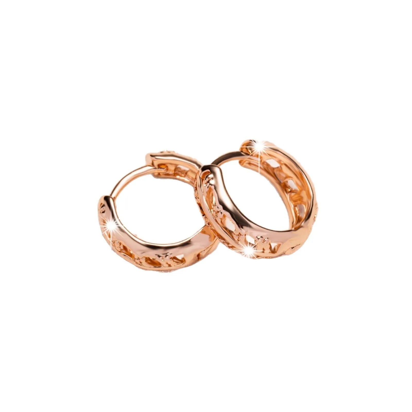 Small copper earrings with hollowed-out leaf and heart shapes in rose gold colour.