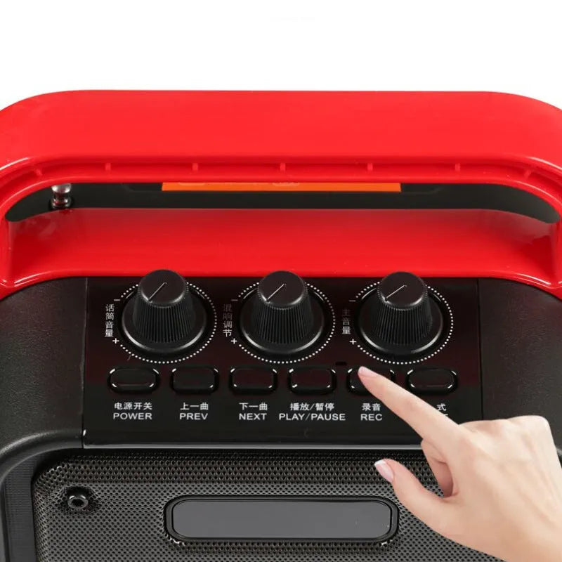 MS62AI portable Bluetooth speaker with wireless microphone on a table, showing control knob and plastic casing.